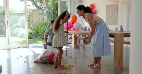 Family Cleaning Party Aftermath in Bright Living Room