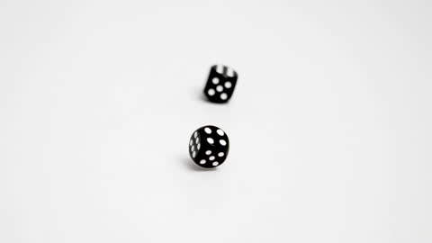 Black Dice Rolling Double Six on White Background in Slow Motion