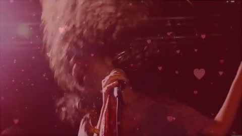 Dynamic Singer on Stage Under Heart-Shaped Lights