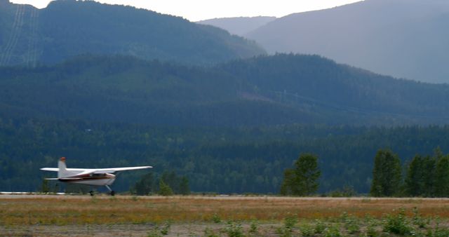 General view of airport with plane on runway and mountains with copy space - Download Free Stock Photos Pikwizard.com