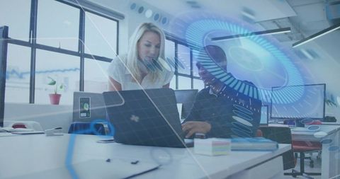 Collaborating on laptop with holographic interface in modern open office mentoring scene