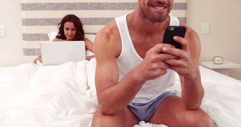 Couple Using Technology in Comfortable Bedroom Setting - Download Free Stock Images Pikwizard.com