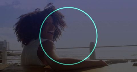 Smiling woman relaxing at sunshine coast on wooden bench