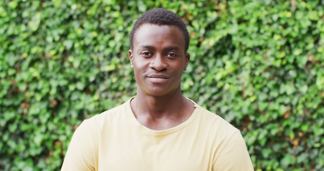 Confident Young Man Smiling Against Green Foliage - Download Free Stock Images Pikwizard.com