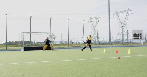 Female field hockey training drill with goalkeeper action