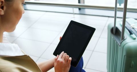 Woman Engaging with Tablet in Airport Terminal - Download Free Stock Images Pikwizard.com