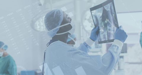 Doctor analyzing x-ray with technological interface overlay