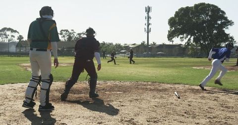 Catchers strategizing on bright modern baseball field
