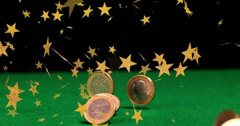 Coins Falling with Golden Stars Above on Green Table