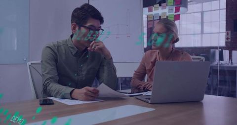 Business Meeting Collaboration with Laptop and Documents in Modern Office