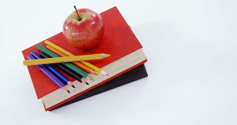 Red Apple on Books with Colorful Pencils for Education Concept
