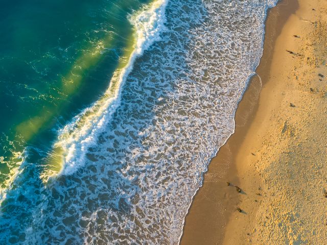 Aerial View of Calm Ocean Waves Meeting Sandy Beach - Download Free Stock Photos Pikwizard.com