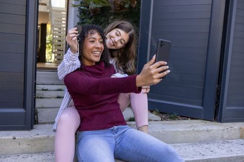 Two Female Friends Taking Selfie on Urban Steps