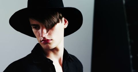 Young man in stylish black hat portrait with copy space