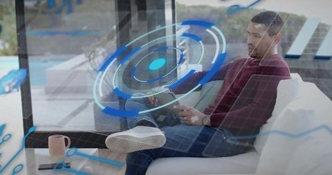 Remote work and smart home HUD concept with man using tablet on modern poolside sofa