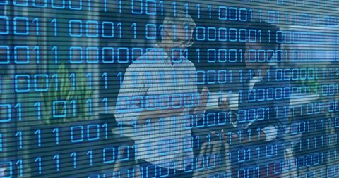 Colleagues Collaborating over Tablet with Blue Binary Code Overlay in Office Corridor