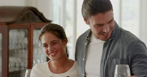 Happy couple celebrating amidst cheerful gathering