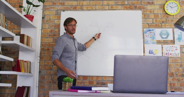 This image can be used for educational materials, online learning platforms, tutoring services, and school websites. It showcases a modern classroom environment and highlights the role of educators in engaging and instructing students. Suitable for articles or presentations about innovative teaching methods, classroom design, and teacher-student interaction.