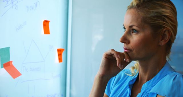 Businesswoman Strategizing in Modern Office with Notes - Download Free Stock Images Pikwizard.com