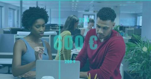 Collaborative data visualization and financial brainstorming at laptop in open office