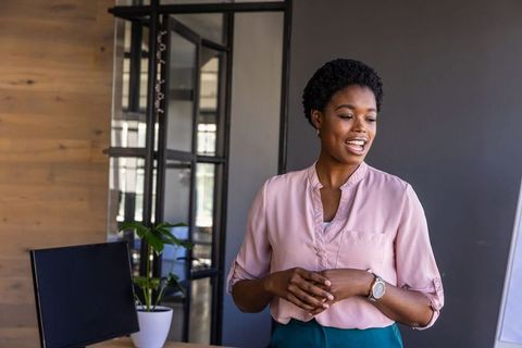 Confident Professional Woman Giving Presentation in Office Setting