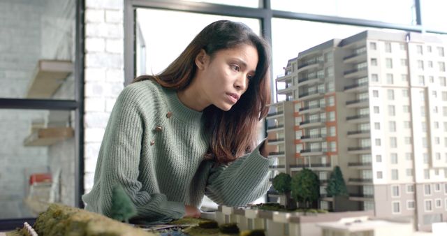 Female Architect Inspecting Building Model in Office - Download Free Stock Images Pikwizard.com