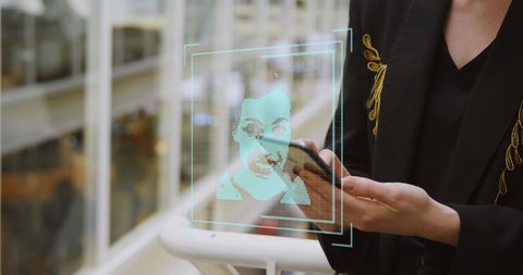 Businesswoman utilizing facial recognition in modern workspace