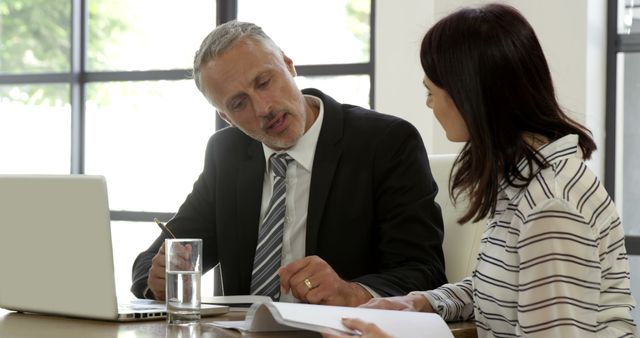 Business Meeting Between Older Professional and Female Colleague in Modern Office - Download Free Stock Images Pikwizard.com