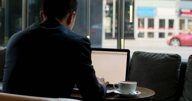 Businessperson Working on Laptop in Cafe - Download Free Stock Images Pikwizard.com