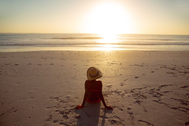 Woman Relaxing on Beach at Sunset - Download Free Stock Photos Pikwizard.com