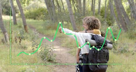 Hikers pointing along woodland trail with large backpack and rolled mat, analytics grid overlay