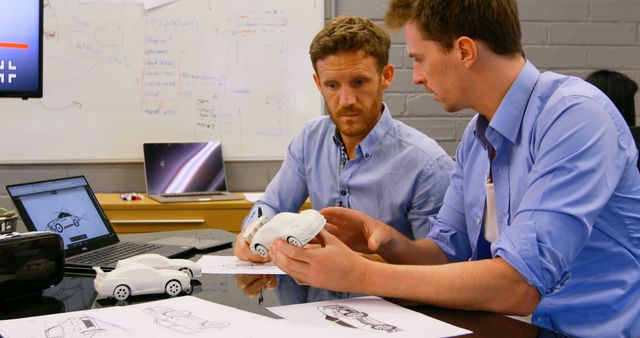 Industrial Designers Discussing Car Prototypes in Modern Office - Download Free Stock Images Pikwizard.com