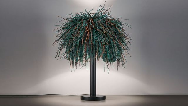 Teal and copper tufted shade on black stem sculptural table lamp for modern interiors