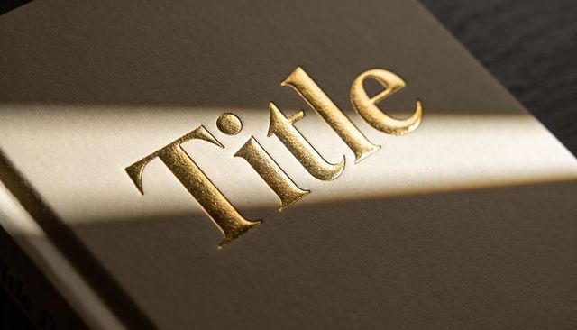 Gold foil embossed title reflecting diagonal sunlight on matte hardcover book cover