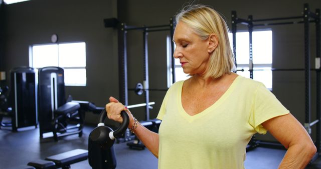 Senior Woman Exercising with Kettlebell in Gym - Download Free Stock Images Pikwizard.com