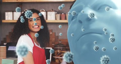 Smiling barista in cafe with virus concept overlay