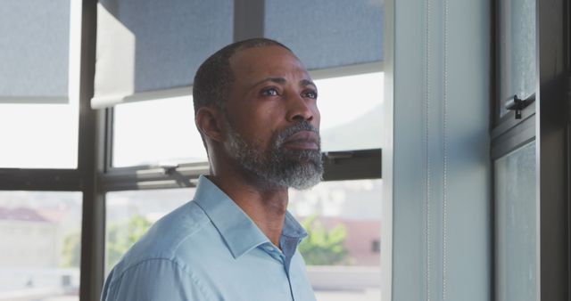 Pensive Man Reflecting by Office Window - Download Free Stock Images Pikwizard.com