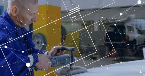 Mechanic using buffer with digital overlay in automotive shop