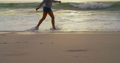 Woman Enjoys Walk on Tranquil Beach at Sunset - Download Free Stock Images Pikwizard.com