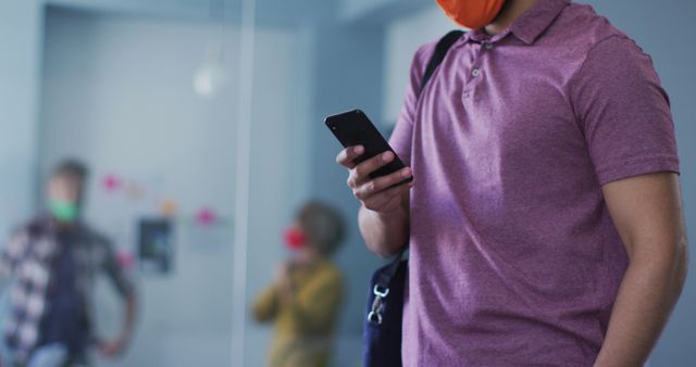 Young Man Wearing Face Mask Using Smartphone in Office - Download Free Stock Images Pikwizard.com