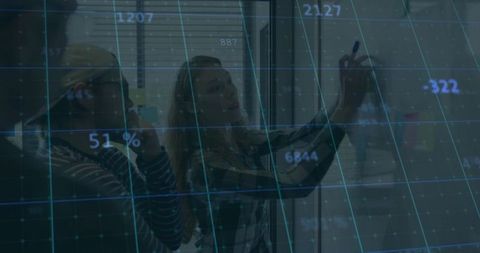 Female Tech Team Collaborating at Glass Board with Digital Data Overlay and Grid Interface