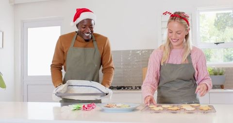 Festive Couple Preparing Homemade Holiday Cookies in Kitchen