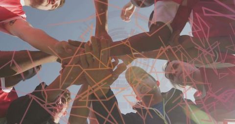 Team of Athletes United in Motivational Huddle on Sports Field