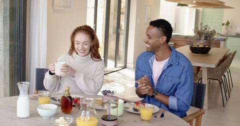 Fun Breakfast Moment Shared by Joyful Couple