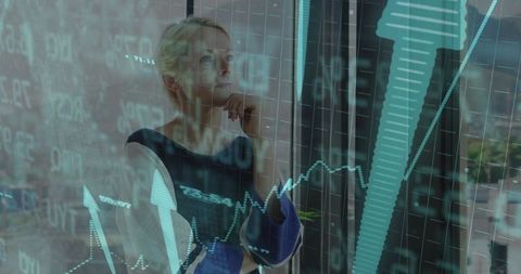Businesswoman Analyzing Financial Charts on Glass Window