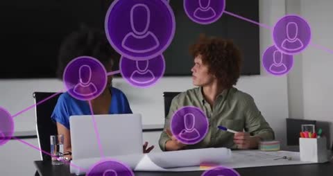 Coworkers Analyzing Blueprint with Digital Network Overlay