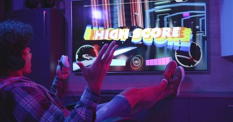 gamer celebrating high score achievement at home gaming setup - Download Free Stock Images Pikwizard.com