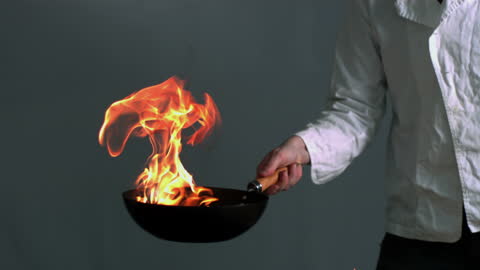 Chef Skillfully Flaming Ingredients in Wok