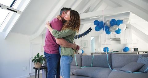 Joyful Couple Embracing at Home Birthday Celebration
