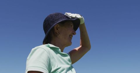 Senior Woman Enjoying Golf on Sunny Day